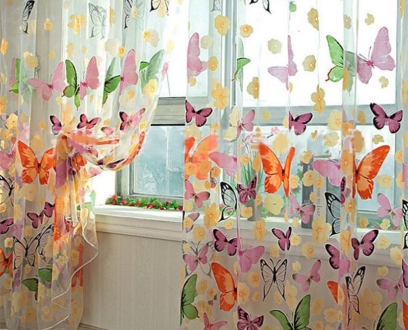 Colorful butterflies on tulle in the girl's room