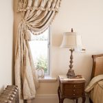 beige curtains on one side of the window