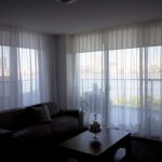 suspended ceiling and curtains in the apartment