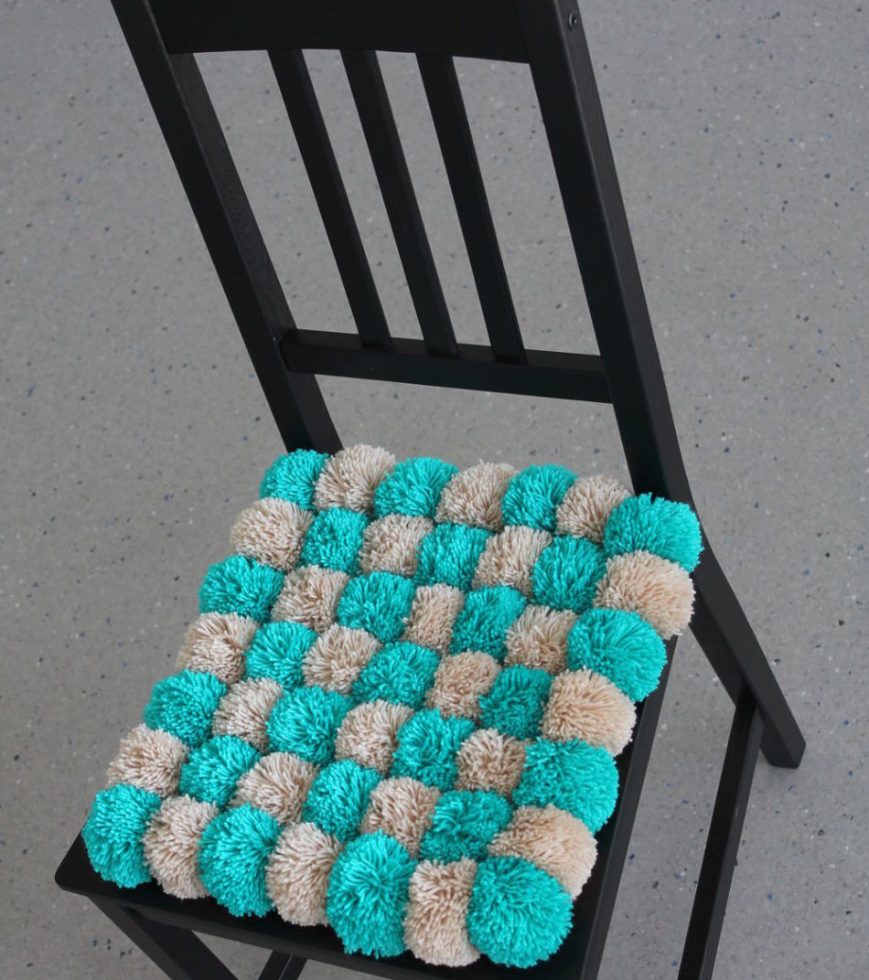 saddle of pompons on the chair